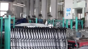 Mass production of car body panels hanging on the cathodic electrocoating (E-Coat) line.